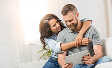 Couple looking at something on a tablet